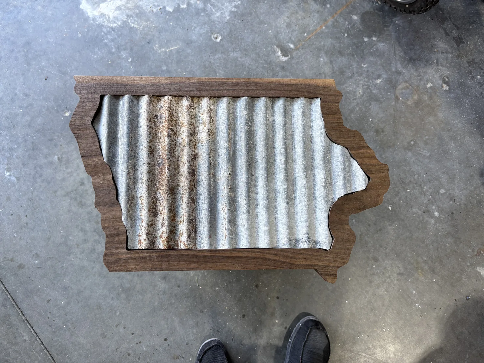 Custom Iowa-shaped wall sign built from a walnut frame around reclaimed corrugated metal